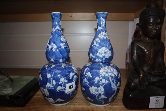 A pair of 19th century Chinese blue and white double gourd vases, Kangxi mark height 25cm